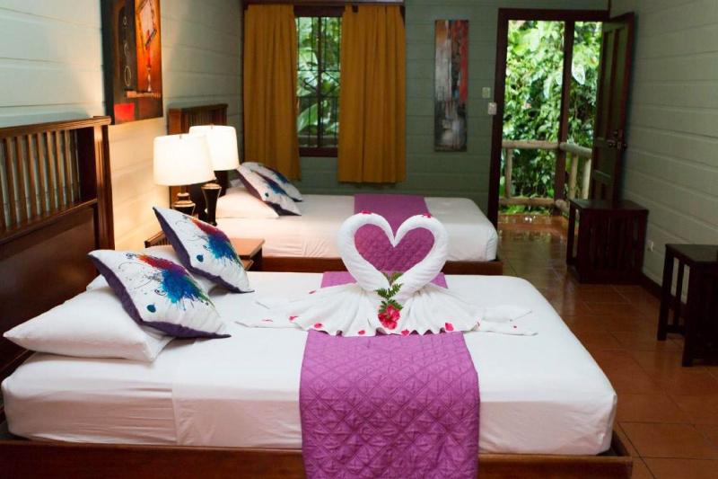 The Accessible Double Room features garden views, tiles floors, and towels folded into a romantic swan design.