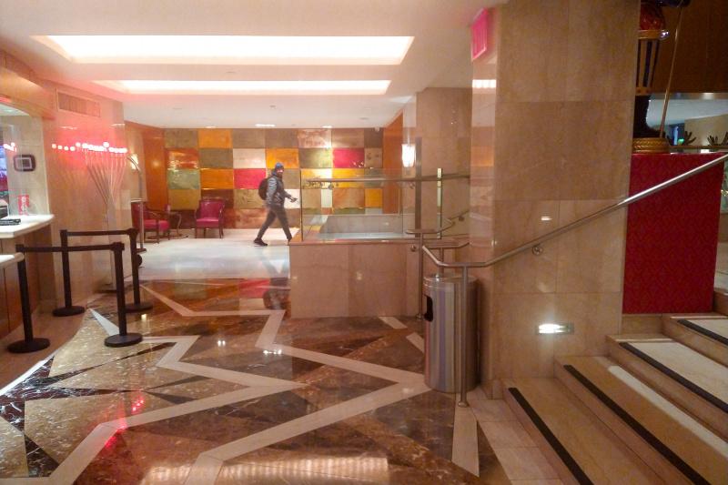 Lobby area with marble tiles, stairs and ramp