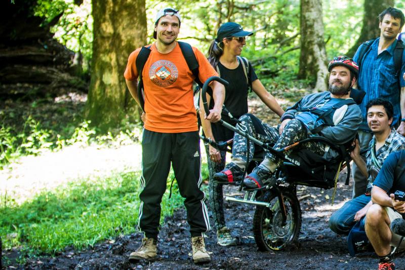 Group of visitors on the Pioneros trekking tour use a jolette all-terrain wheelchair.
