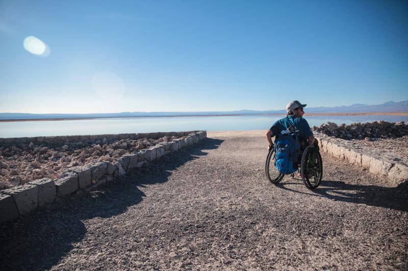 A man in a wheelchair on the edge of the vast salt flats.